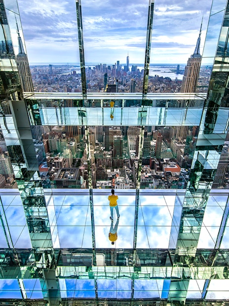 Observation deck view from SUMMIT One Vanderbilt, showcasing New York City skyline and mirrored reflections.