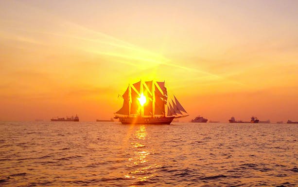 Sailing ship at sunset during the Royal Albatross dinner cruise.