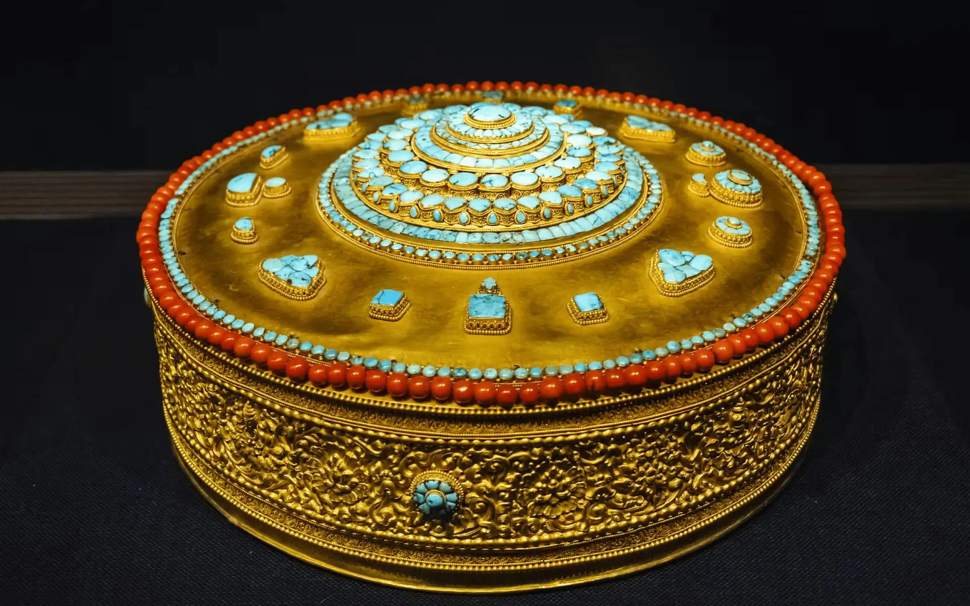 Golden ornate box with turquoise and coral inlays, displayed at National Palace Museum.