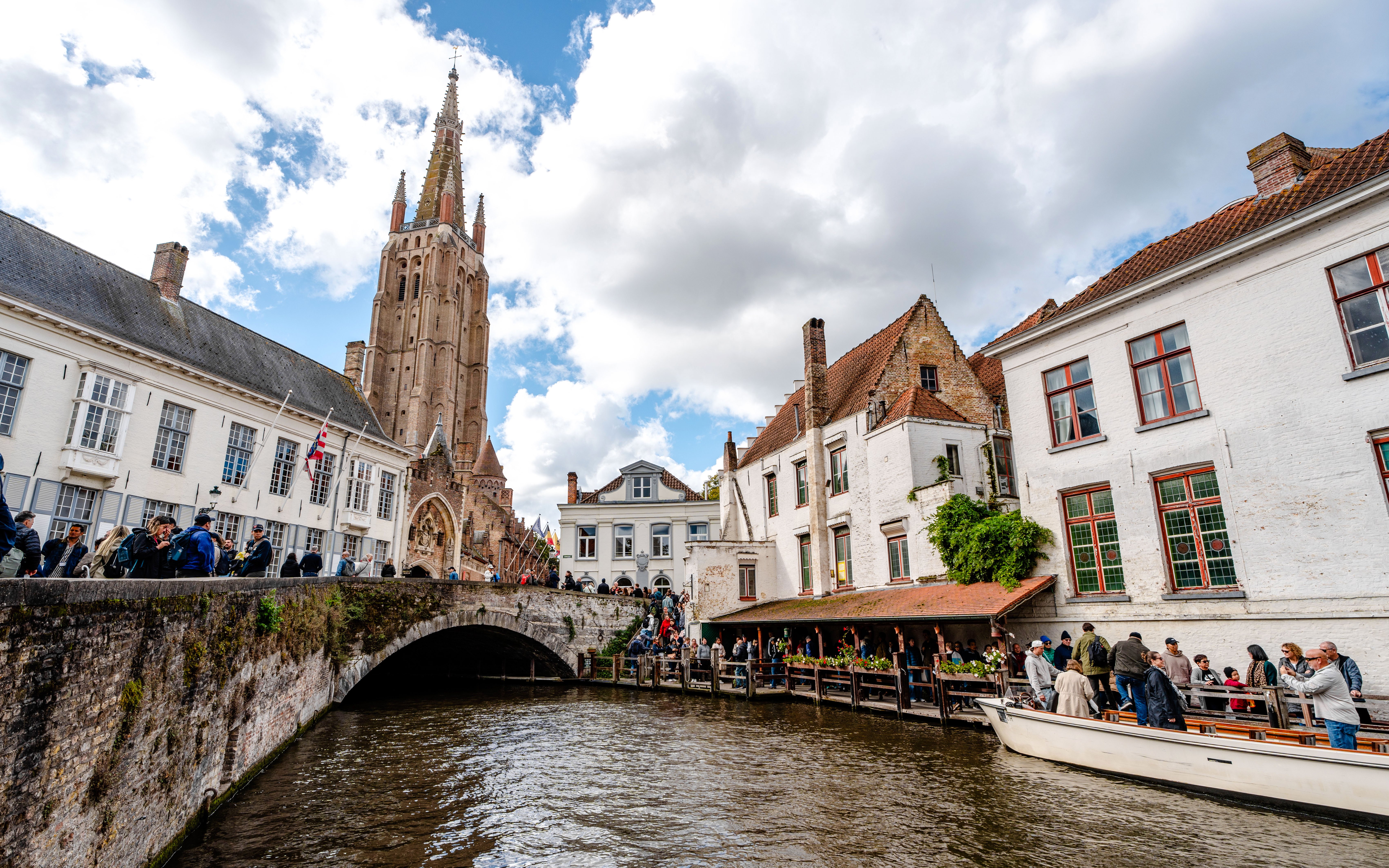 Scenic canal in Bruges, Belgium with Church of Our Lady in the background.