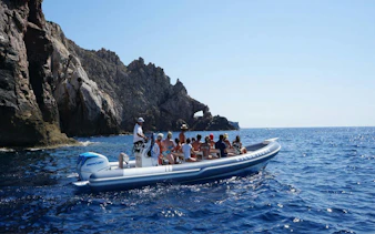 Dinghy tour near rocky cliffs at Pan di Zucchero, Cagliari.