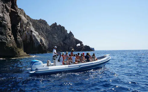 Dinghy tour near rocky cliffs at Pan di Zucchero, Cagliari.