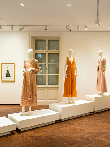 Mannequins displaying elegant dresses at the Heidi Horten Collection exhibition.