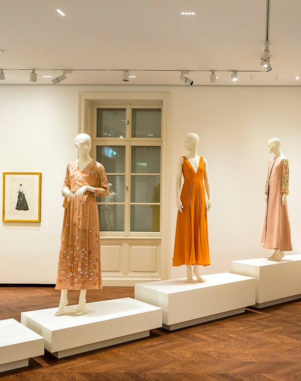 Mannequins displaying elegant dresses at the Heidi Horten Collection exhibition.