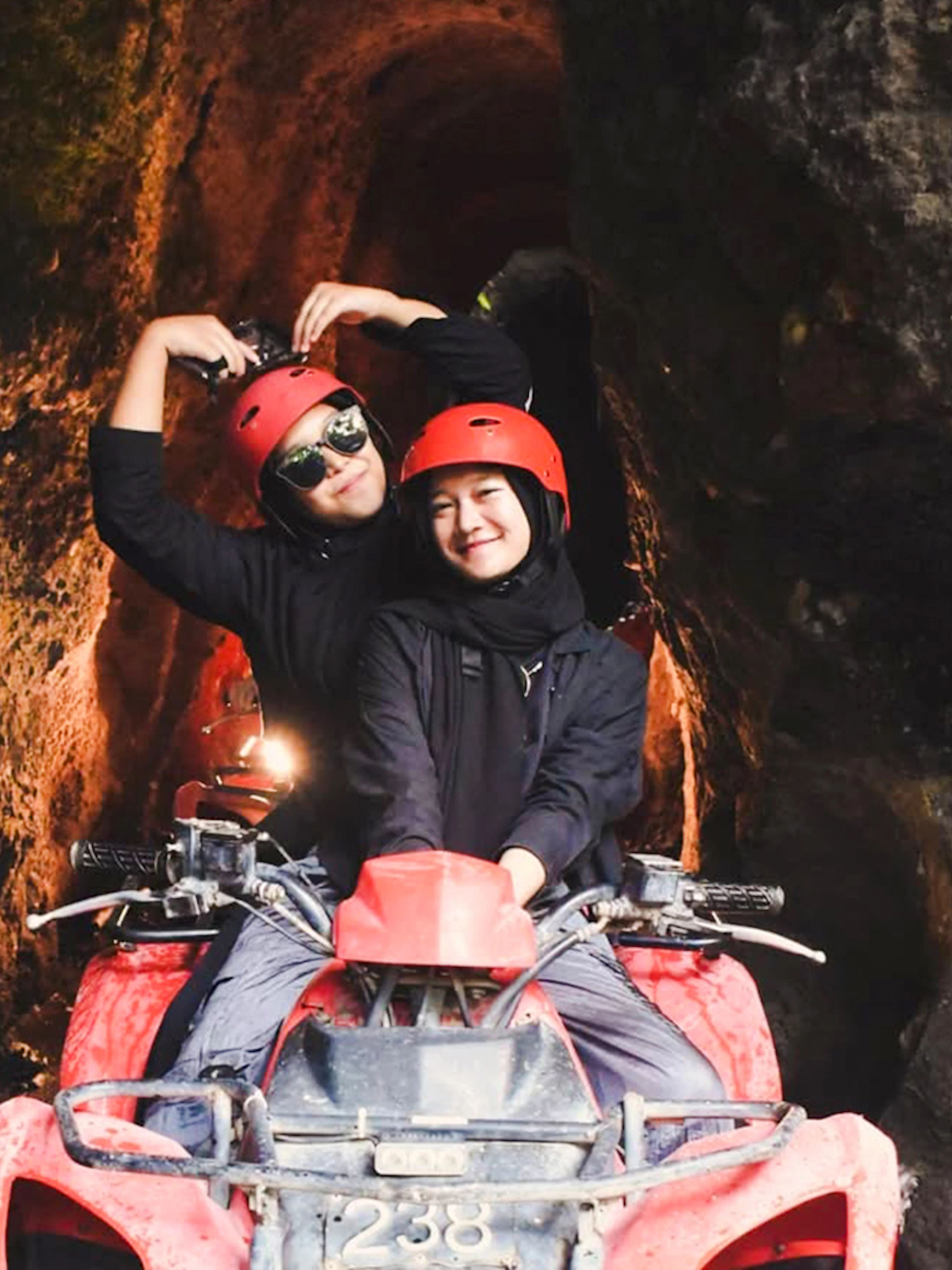 ATV ride through Kuber long tunnel with two people wearing helmets.