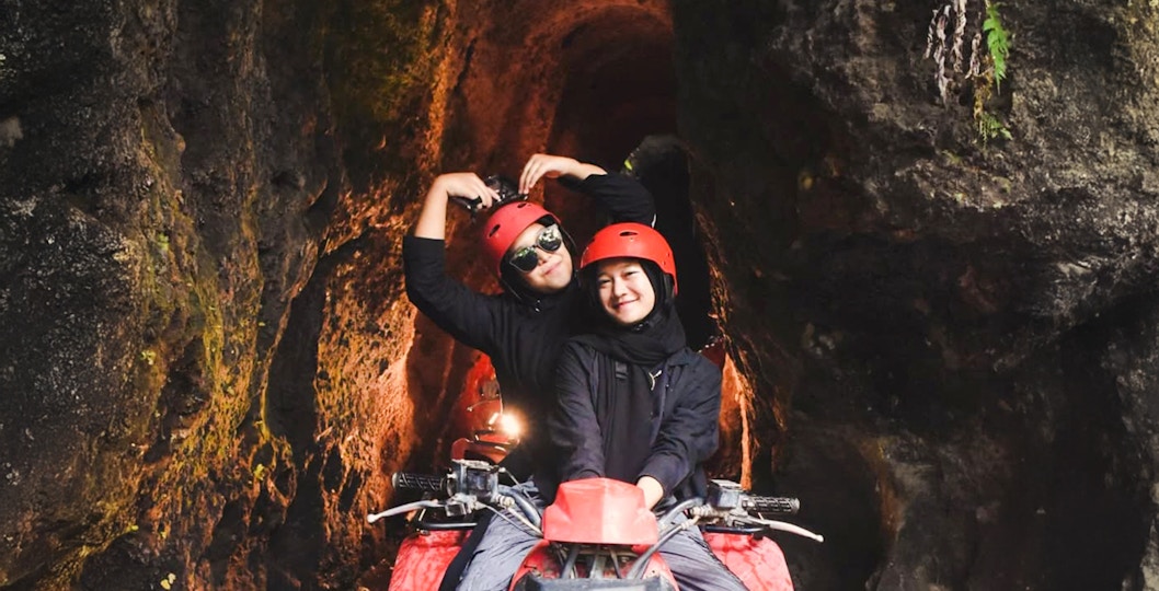 ATV ride through Kuber long tunnel with two people wearing helmets.