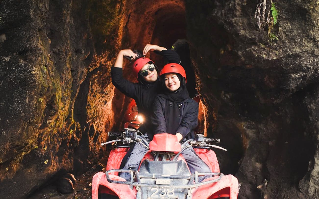 ATV ride through Kuber long tunnel with two people wearing helmets.