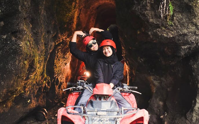 ATV ride through Kuber long tunnel with two people wearing helmets.