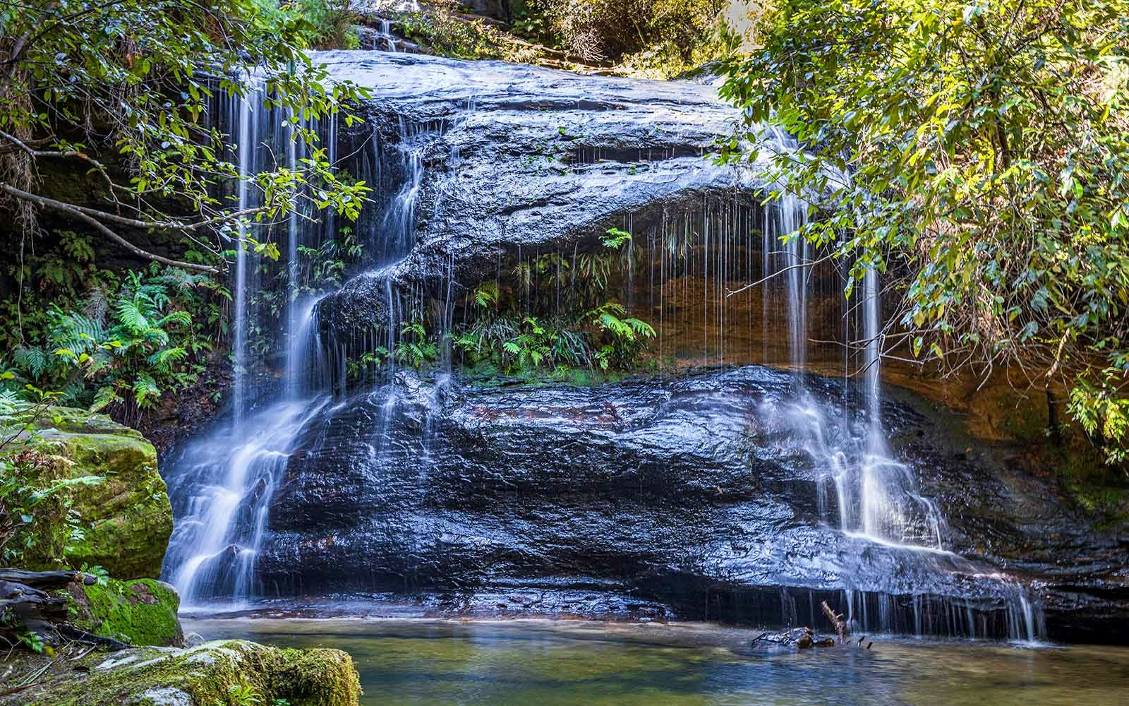 Cataract Falls on South Lawson Waterfall Circuit, Blue Mountains NSW, surrounded by lush greenery.