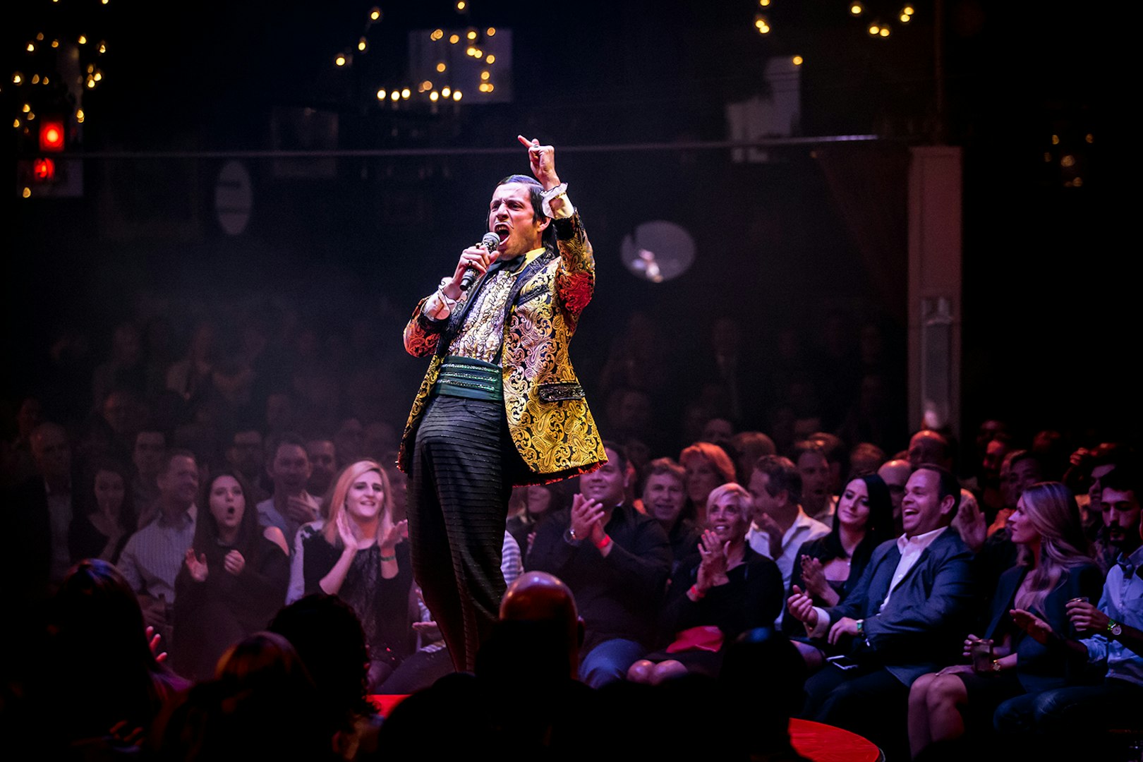 Performer on stage at Absinthe show in Las Vegas, engaging audience.
