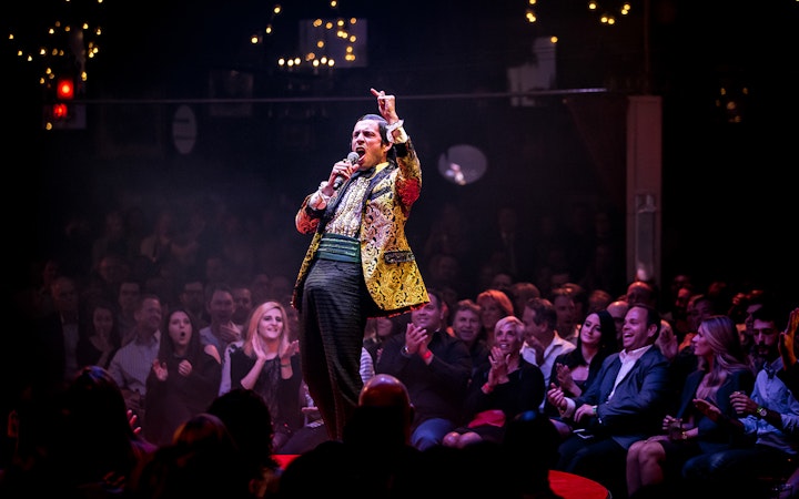 Performer on stage at Absinthe show in Las Vegas, engaging audience.