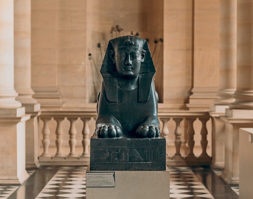 Sculptures at Louvre Museum, Paris, showcasing a unique collection of historical art pieces in a well-lit gallery
