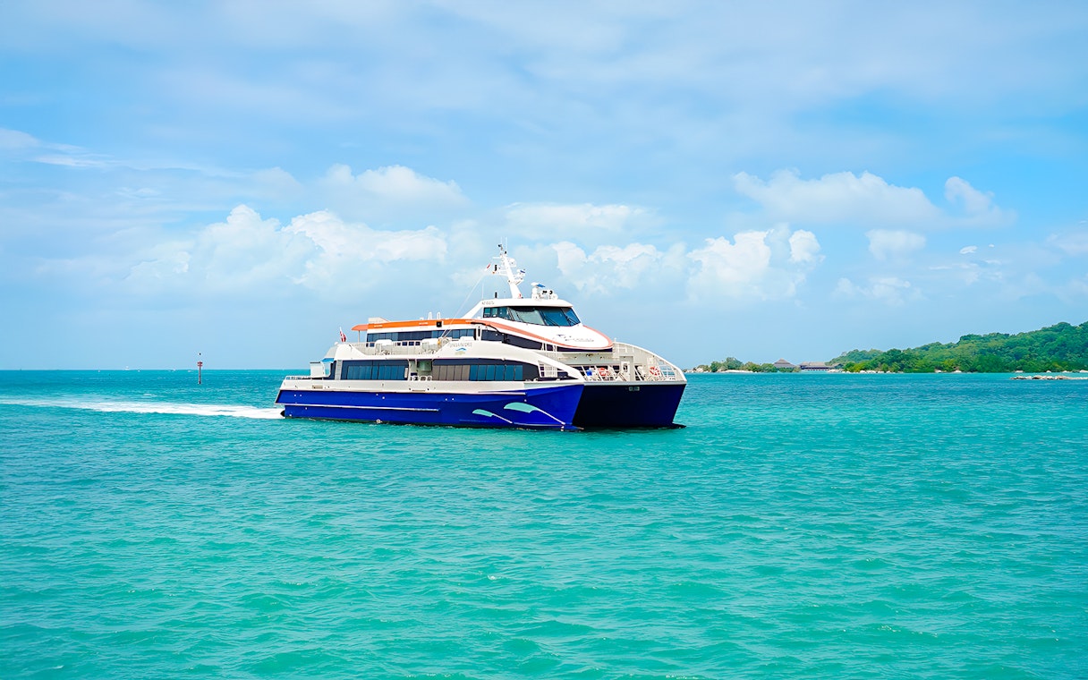 Ferry traveling from Singapore to Bintan Resorts across turquoise waters.