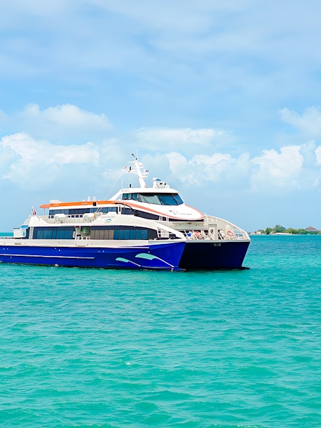 Ferry traveling from Singapore to Bintan Resorts across turquoise waters.