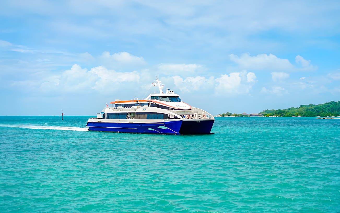 Ferry traveling from Singapore to Bintan Resorts across turquoise waters.