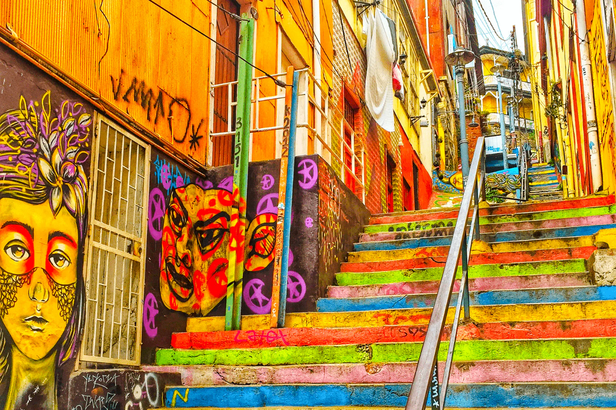 Colorful street art and painted stairs in Valparaíso, Chile.