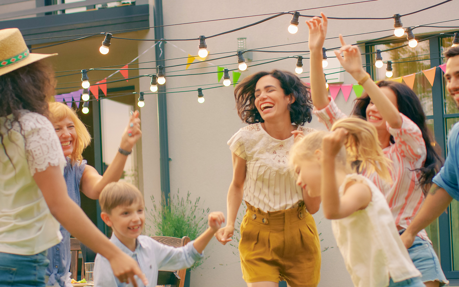 Family and Friends Dancing together at a Villa Garden Party Celebration.