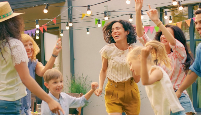 Family and Friends Dancing together at a Villa Garden Party Celebration.