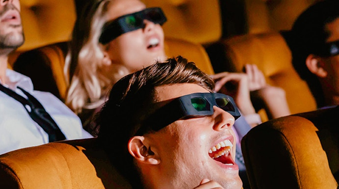 Visitors enjoying a 4D experience at Sentosa 4D AdventureLand, wearing 3D glasses.