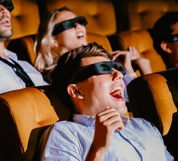 Visitors enjoying a 4D experience at Sentosa 4D AdventureLand, wearing 3D glasses.