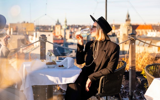 Guests enjoying drinks on a rooftop during Sky Bar Prague Aperitivo tour.