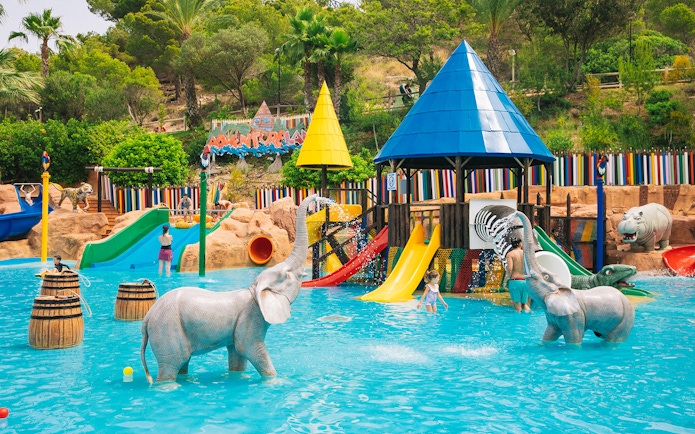 Children playing in water with elephant statues at Adventureland, Aqualandia Benidorm.