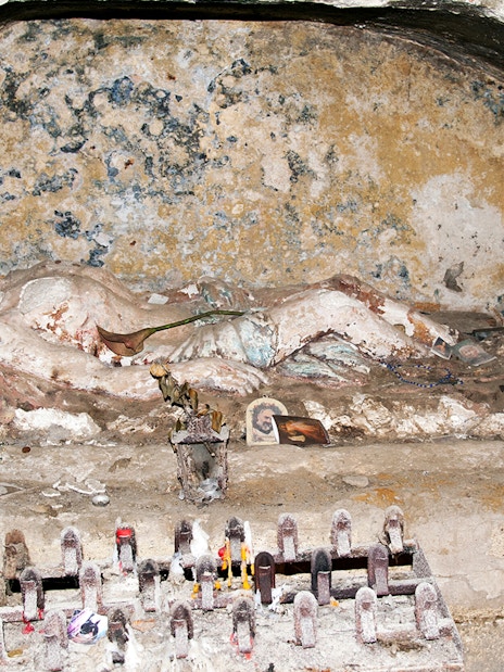 Ancient tomb with religious artifacts in Catacombs of San Gennaro, Naples.