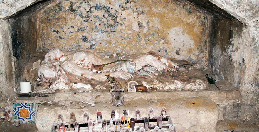 Ancient tomb with religious artifacts in Catacombs of San Gennaro, Naples.