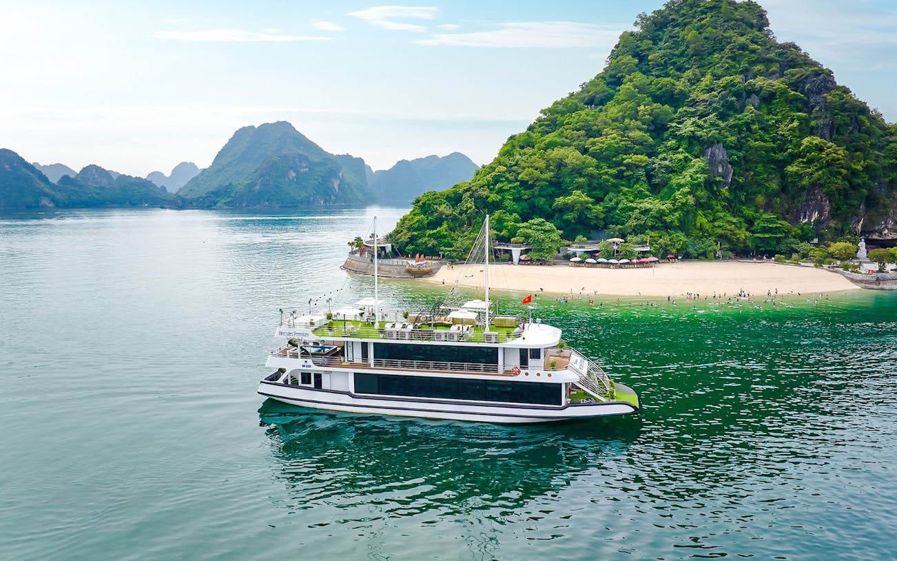 Cruise ship Hercules Premium near a scenic island in Halong Bay, Vietnam.