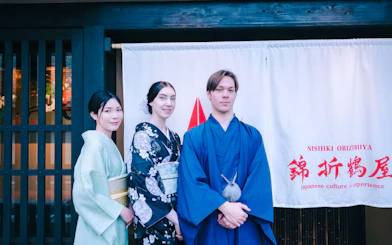 Tourists in traditional attire outside a Japanese tea ceremony venue.