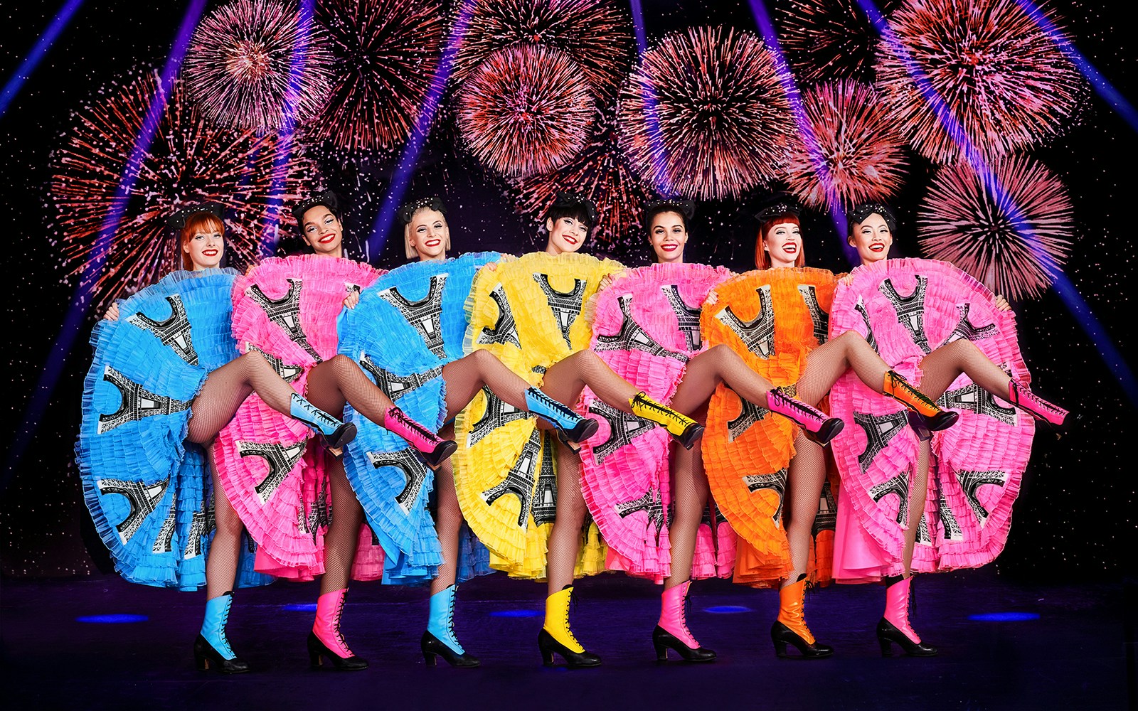 Dancers in colorful dresses performing at Paradis Latin, Paris.