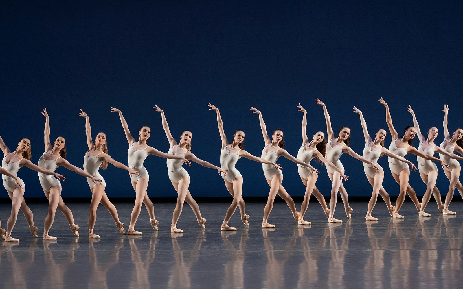 Ballet dancers performing in unison at New York City Ballet.