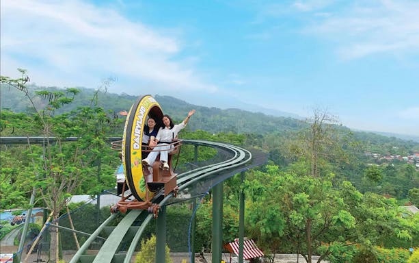 Sky Ride at Dairyland Farm Theme Park Prigen with two people enjoying the view.