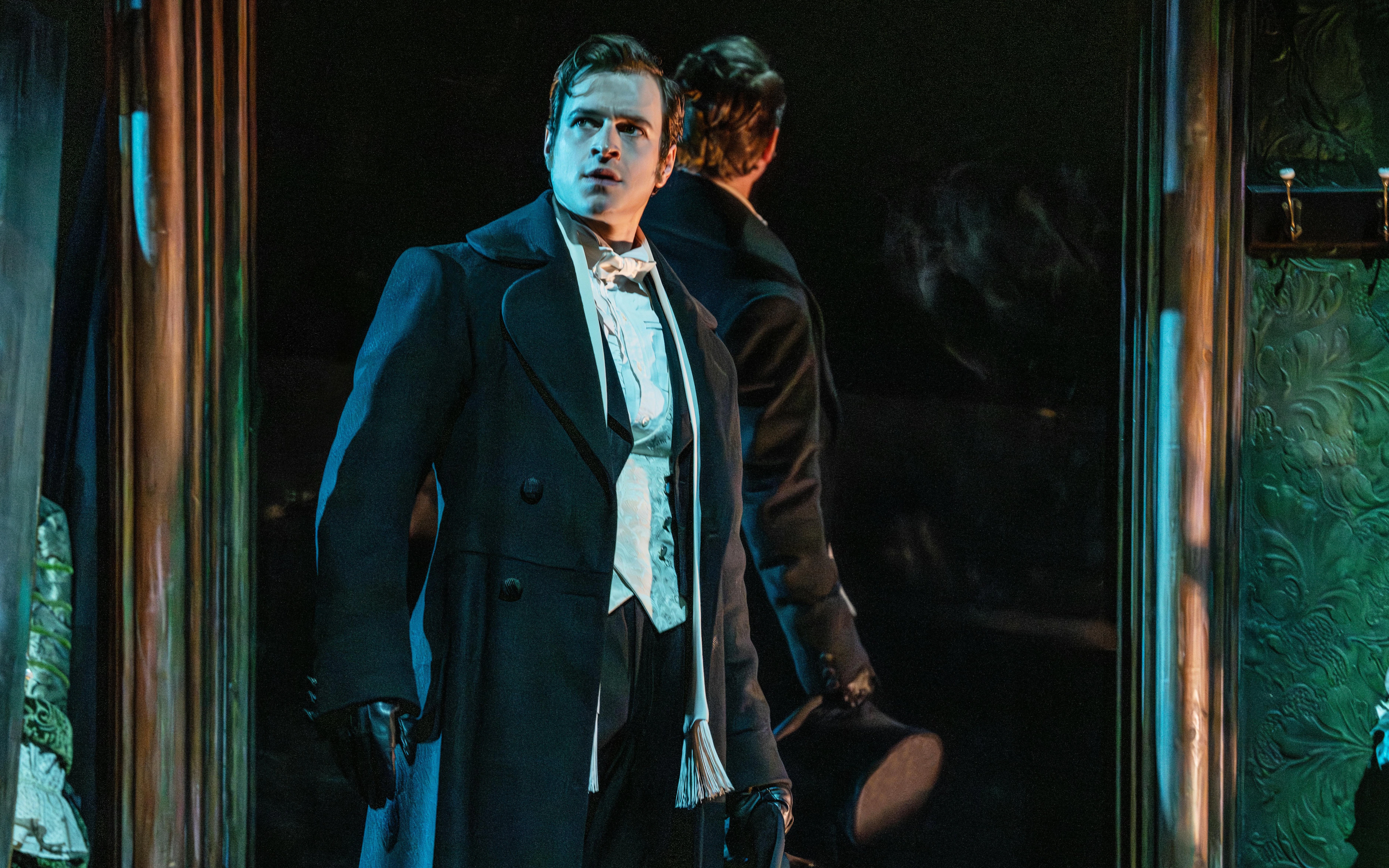Actor in period costume on stage during Phantom production.