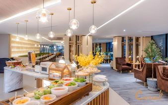 Buffet and seating area at Coral Cosmo Lounge, Concourse C, Bangkok airport, Thailand.