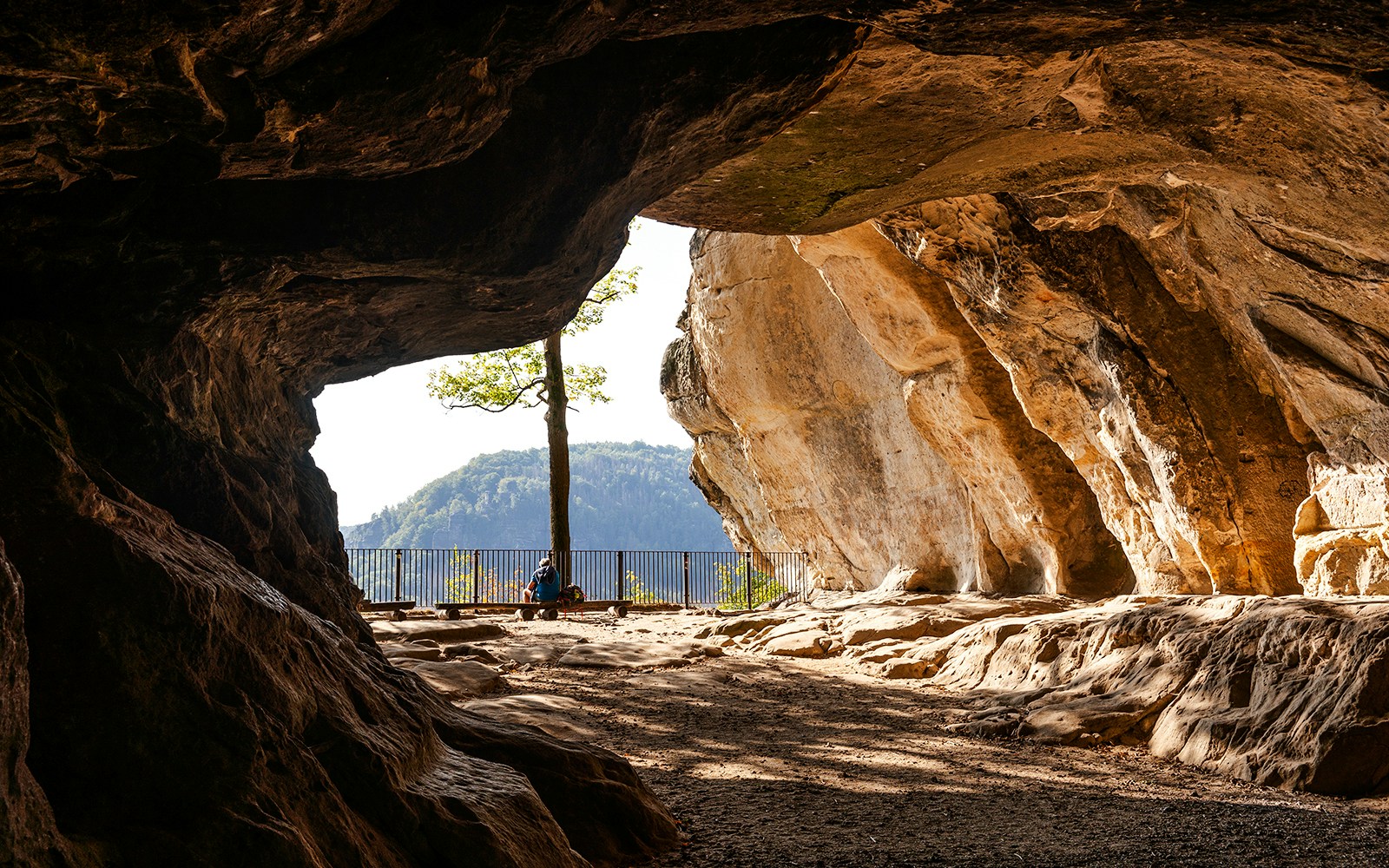 Kuhstall rock cave with view of Saxon Switzerland landscape, Germany.