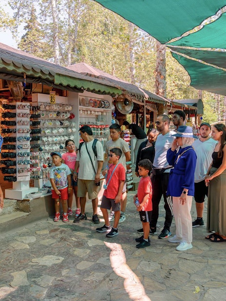 Tourists exploring a souvenir shop in Antalya during a city sightseeing tour.