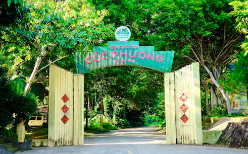 Entrance gate to Cuc Phuong National Park, surrounded by lush greenery, Ninh Binh.
