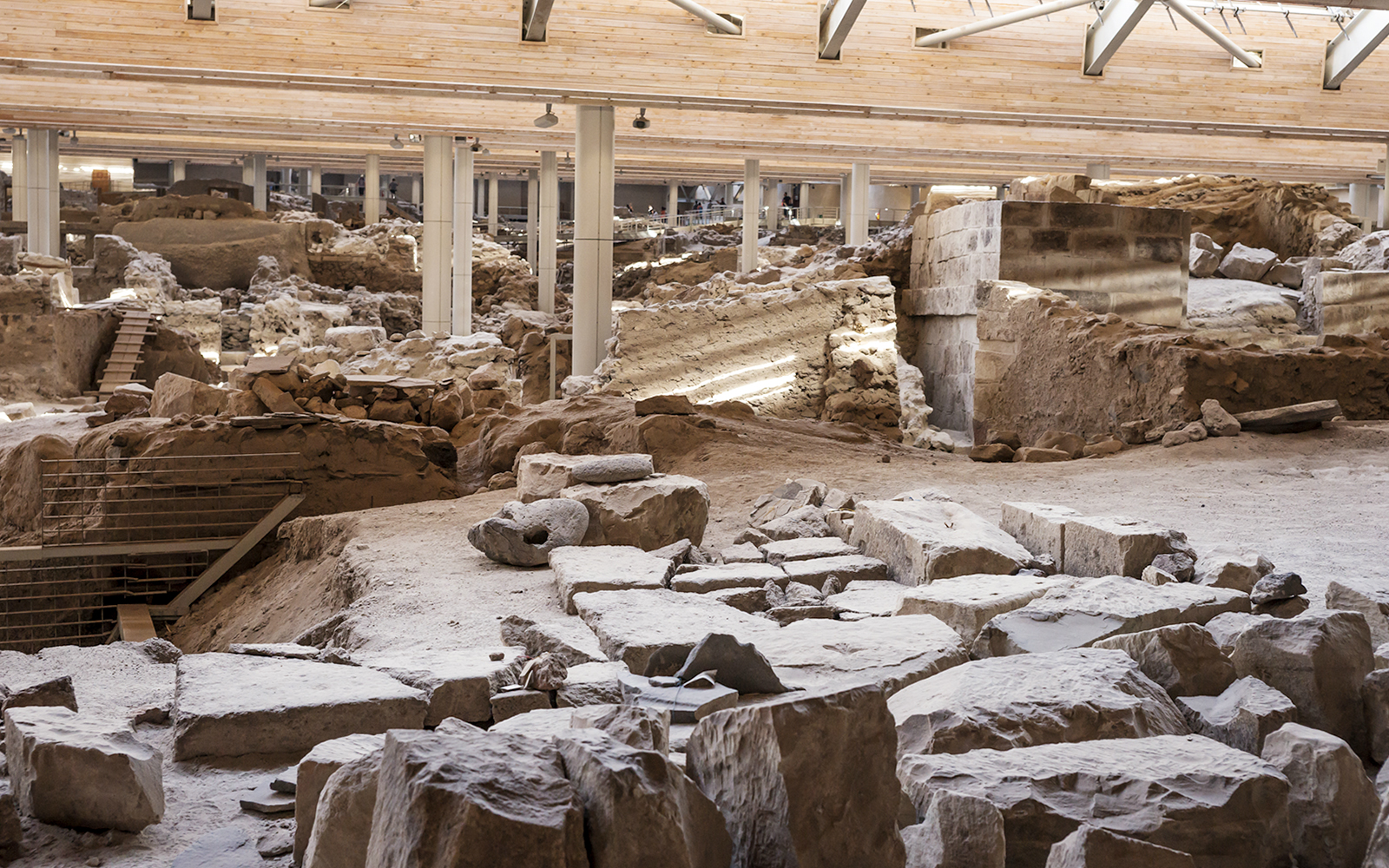 Akrotiri Excavations interior with ancient ruins and stone structures in Santorini.