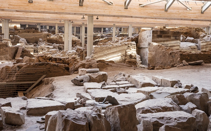 Akrotiri Excavations interior with ancient ruins and stone structures in Santorini.