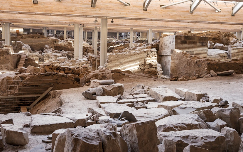 Akrotiri Excavations interior with ancient ruins and stone structures in Santorini.