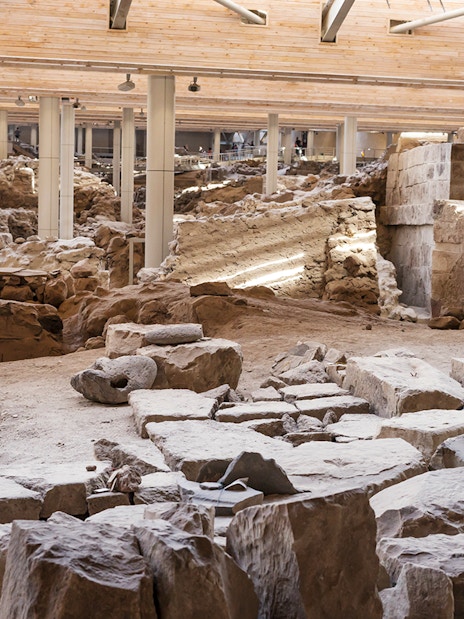 Akrotiri Excavations interior with ancient ruins and stone structures in Santorini.