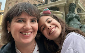 Smiling visitors at the Fountain of Neptune, Bologna, during the city exploration game.