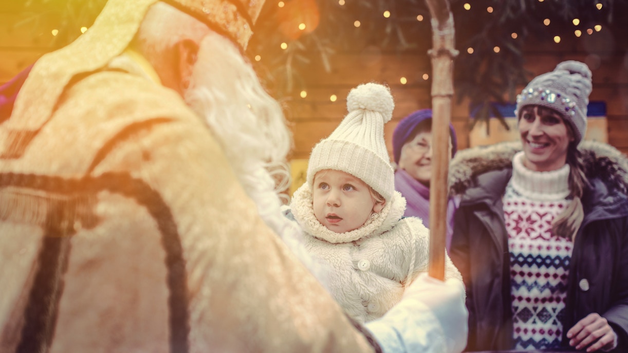Child meeting St. Nicholas at Prague Christmas market in December.