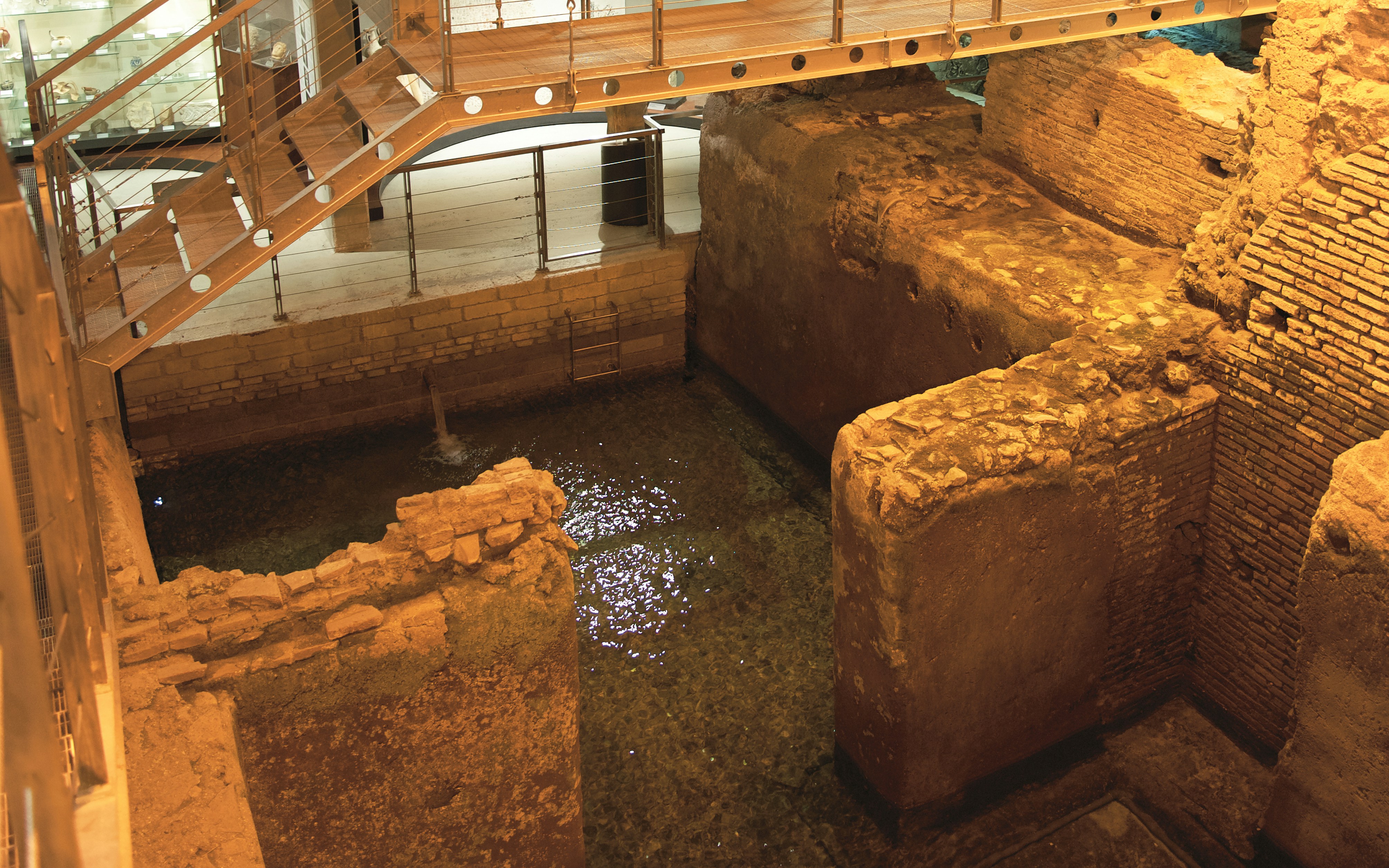 Navona Square underground ruins with ancient stone walls and water in Rome.