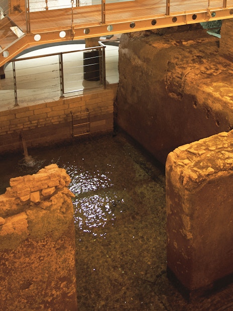 Navona Square underground ruins with ancient stone walls and water in Rome.