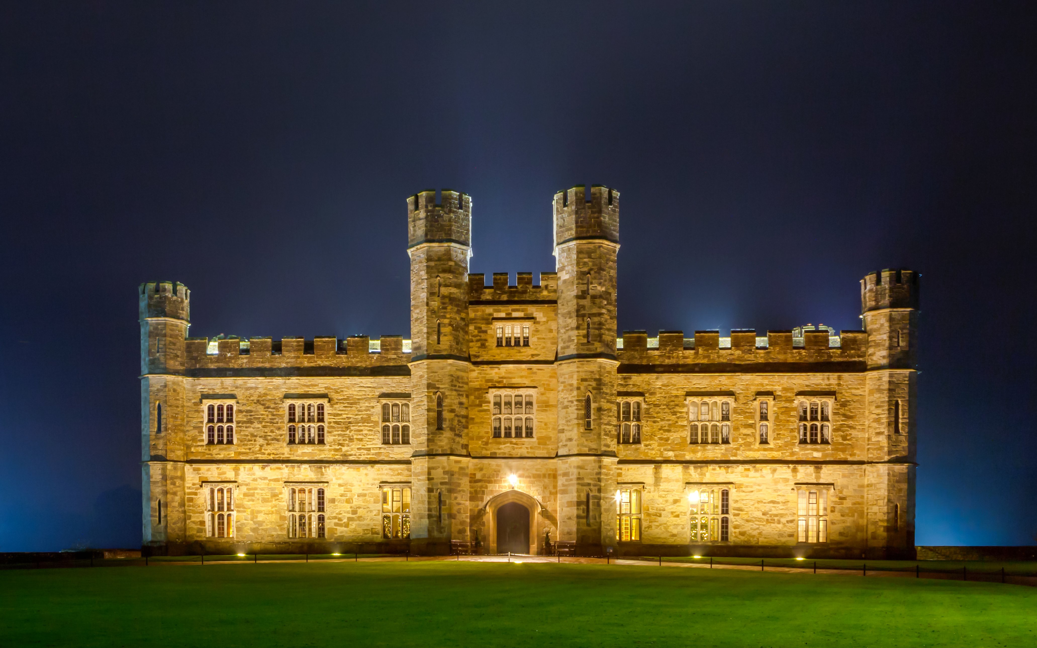 Leeds Castle illuminated at night during Christmas season.