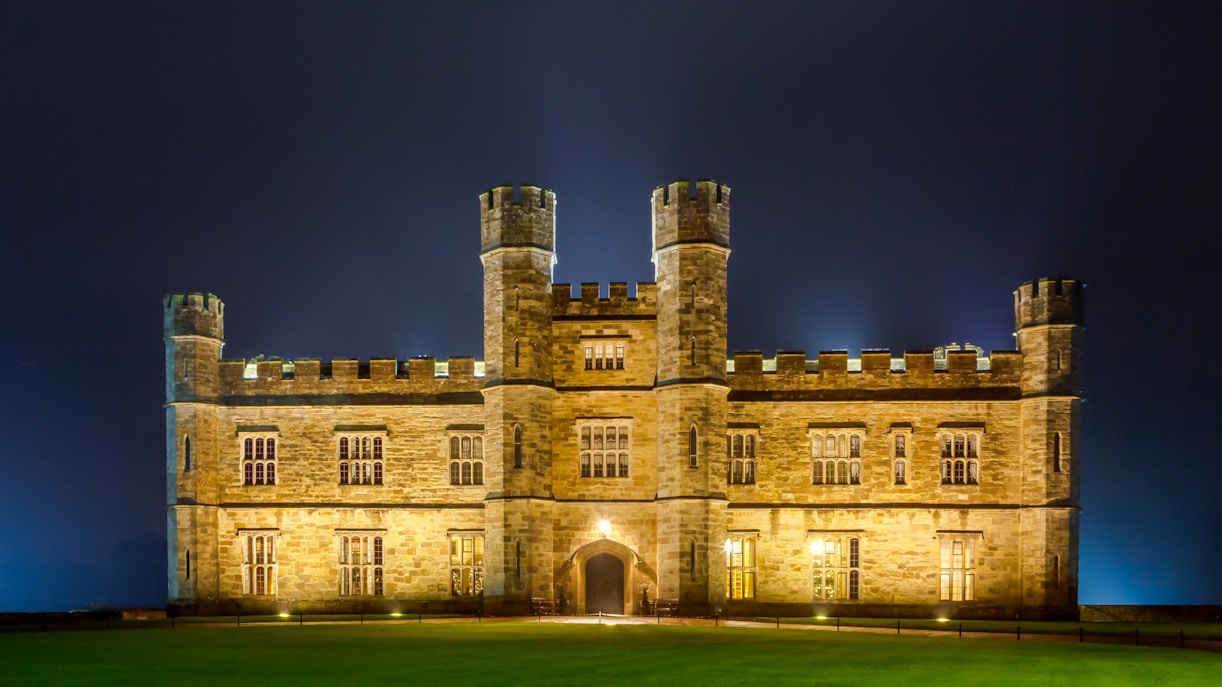 Leeds Castle illuminated at night during Christmas season.