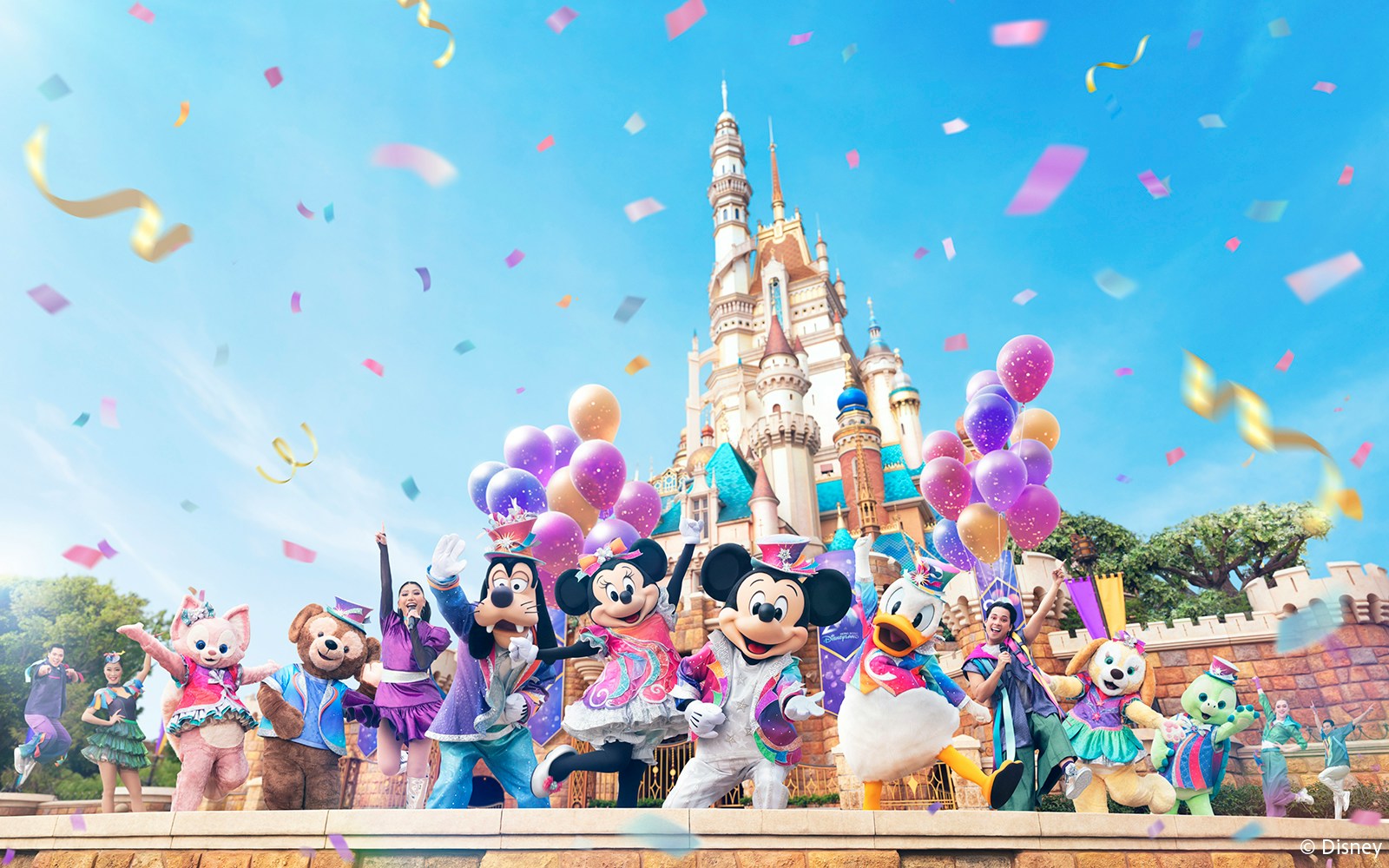 Disney characters celebrating 20th anniversary at Hong Kong Disneyland with castle backdrop.