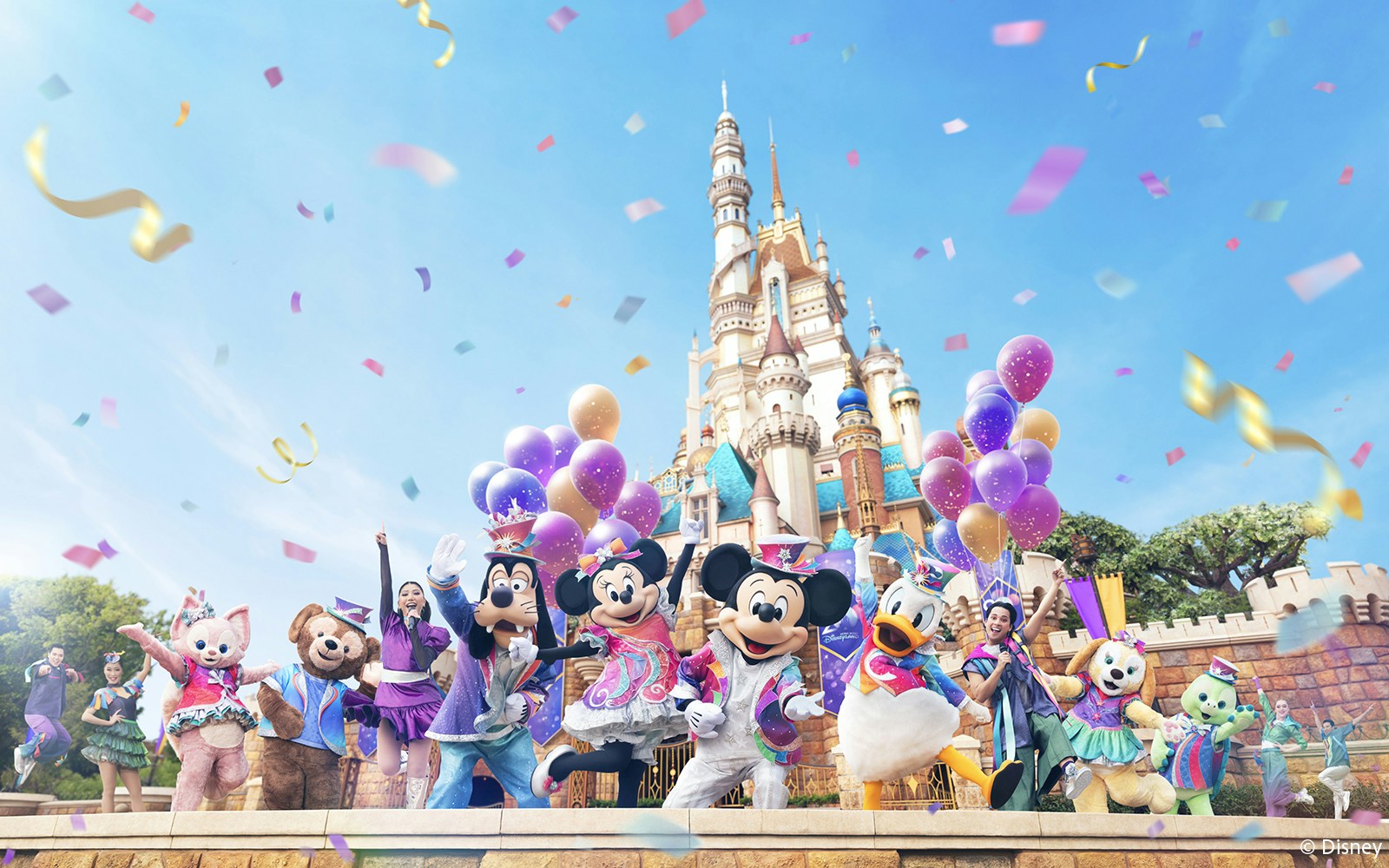 Disney characters celebrating 20th anniversary at Hong Kong Disneyland with castle backdrop.